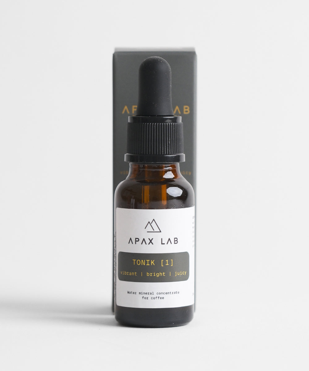 APAX Lab Tonik water mineral front view of bottle standing infront of box bottle comes in both sitting on a white surface with white background