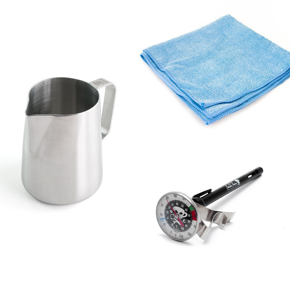 Stainless steel pitcher, blue microfiber cloth, and temperature gauge with skull design on a white background