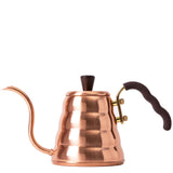 Copper kettle with wooden handle and spout on a white background