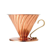 Copper coffee dripper on a white background