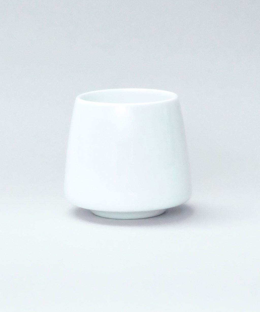 White origami aroma flavor ceramic cup on a light gray background