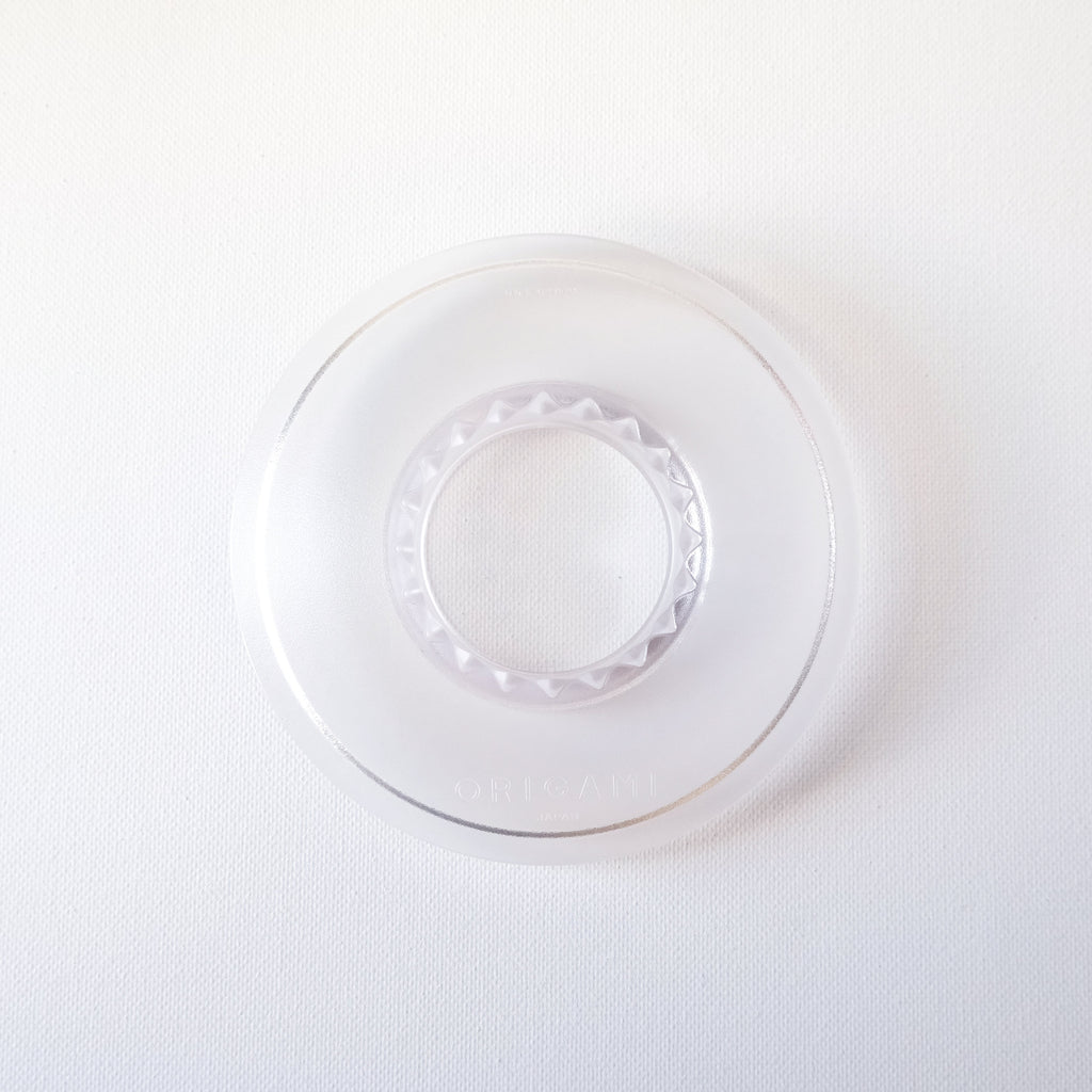 Clear resin dripper holder on a white background