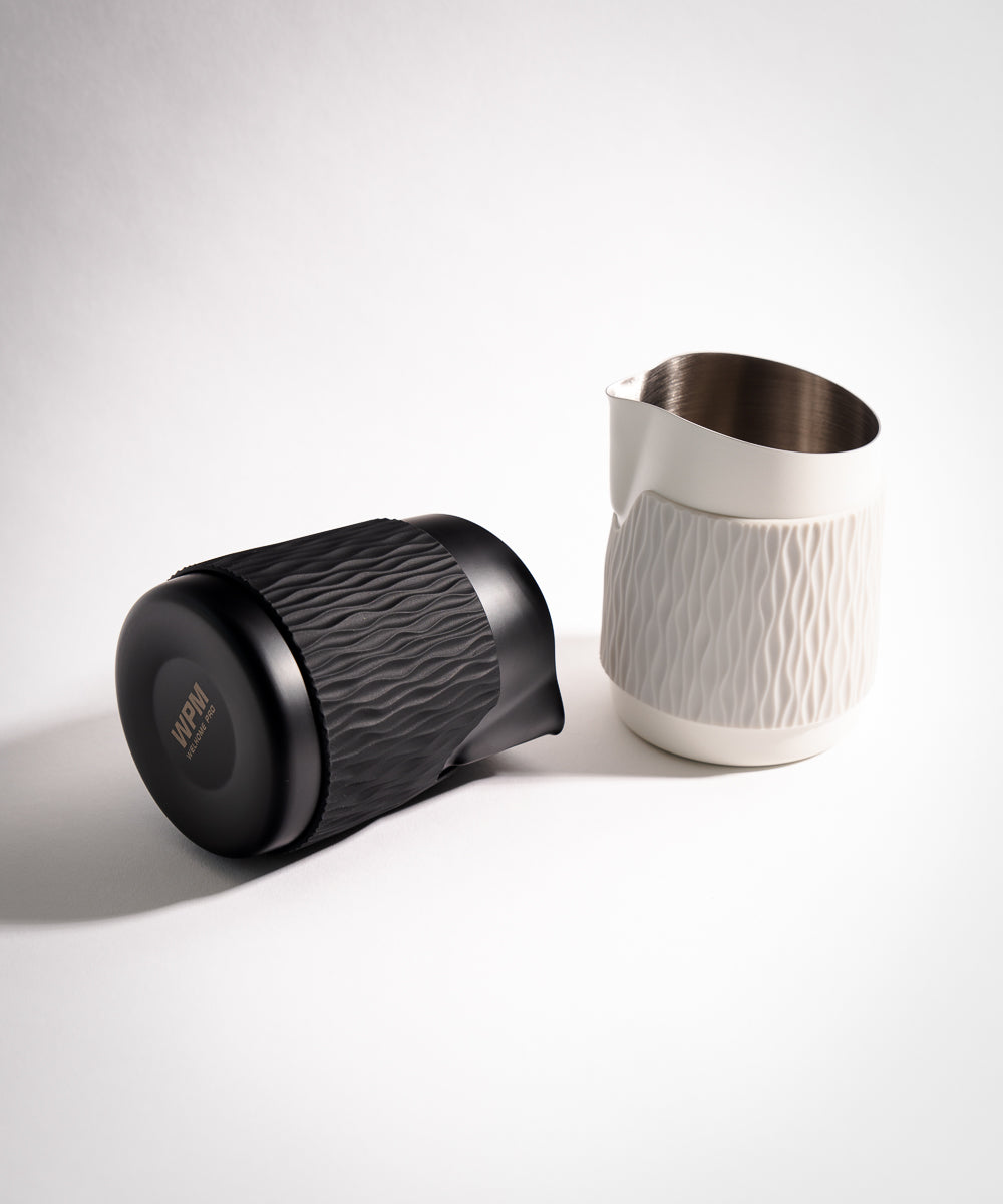 WPM Pitcher monochrome handleless latte art pitcher for precision pouring pictured in Matte White and Midnight Black