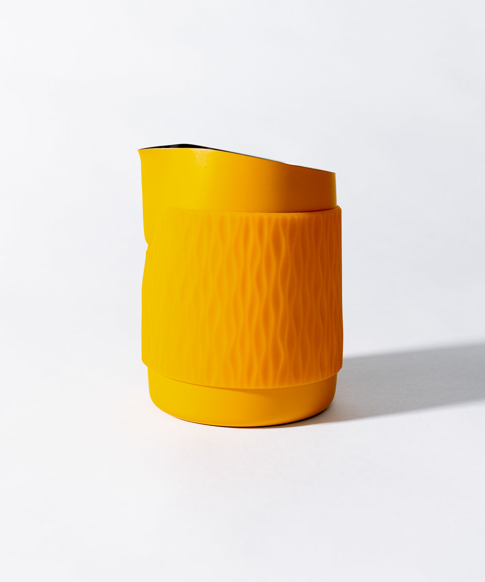WPM Pitcher in Marigold shown from the side, featuring a sleek handleless design for latte art