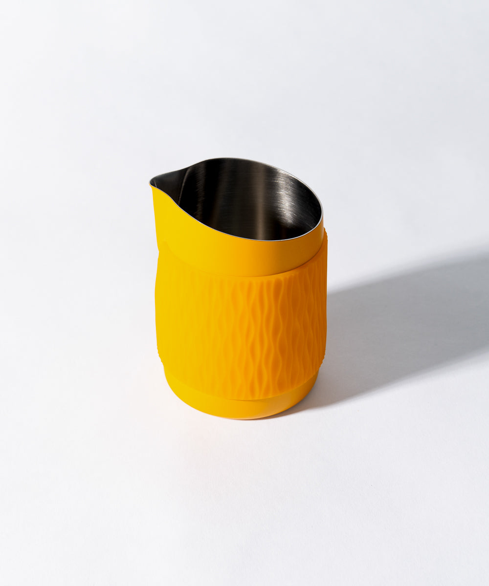 WPM Pitcher in Marigold shown from the side, featuring a sleek handleless design for latte art