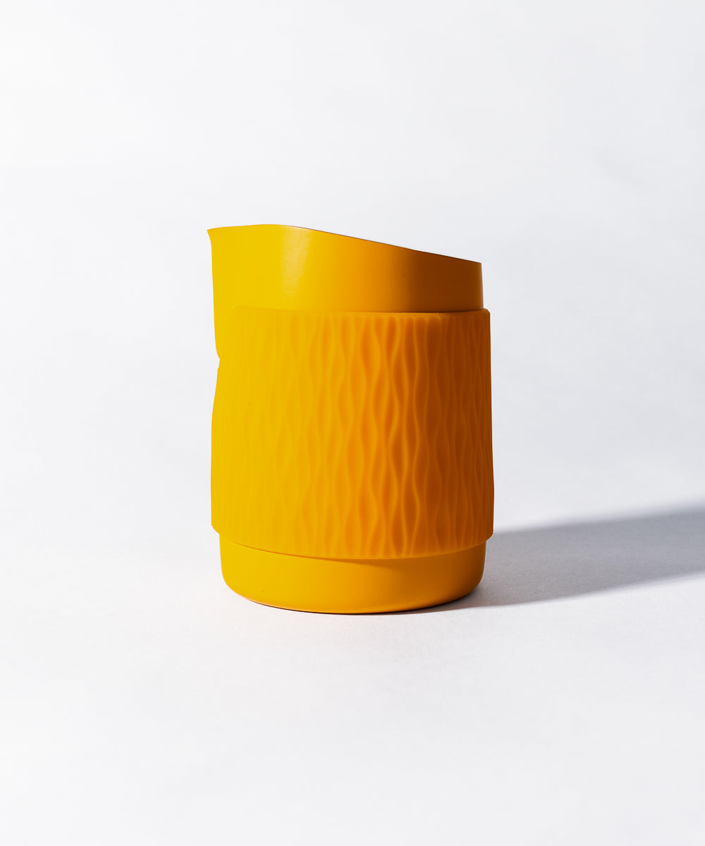 WPM Pitcher  in Marigold color shown from the side, featuring a sleek handleless design for latte art