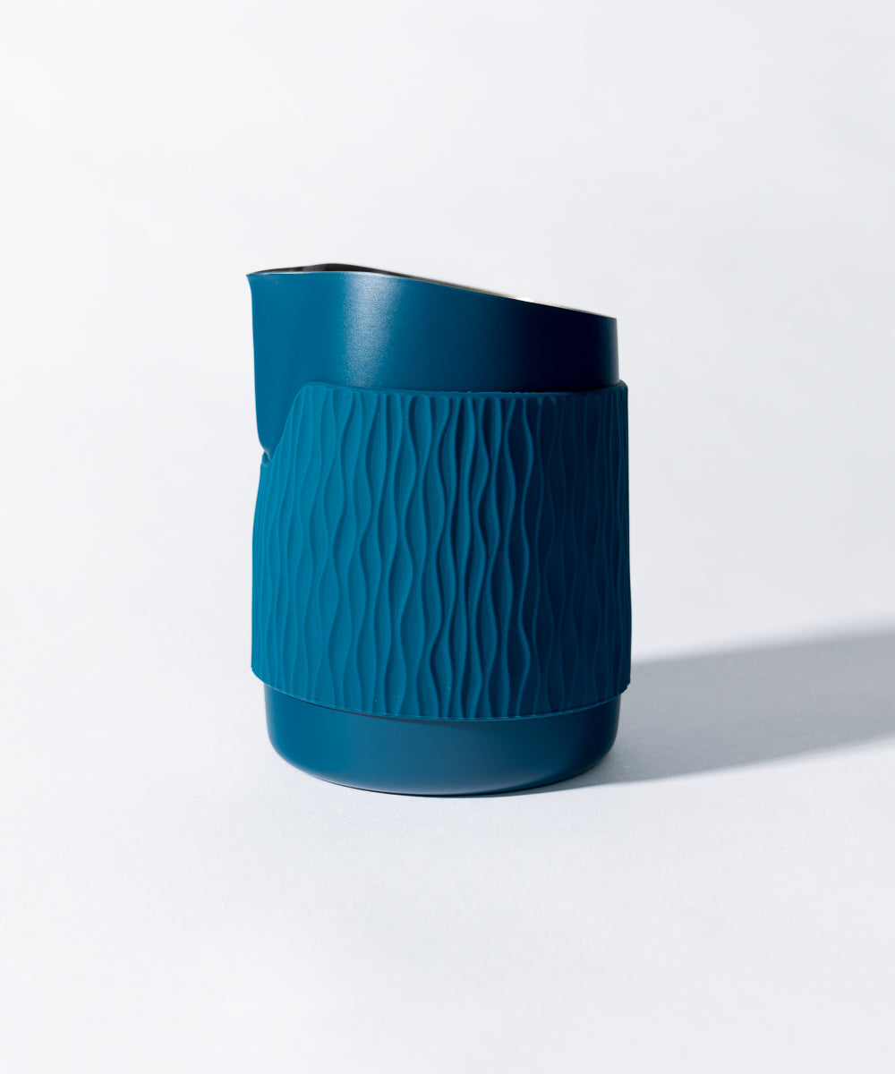 WPM Pitcher in Marina Blue shown from the side, featuring a sleek handleless design for latte art