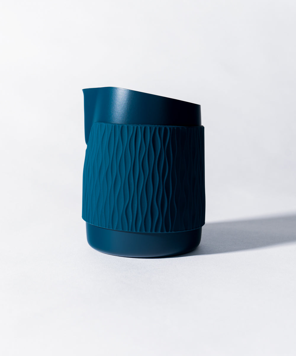 WPM Pitcher in Marina Blue shown from the side, featuring a sleek handleless design for latte art