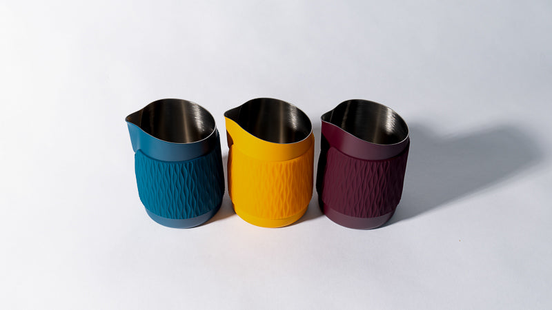 WPM Pitcher handleless latte art pitchers in Marina Blue, Marigold, and Aubegine - designed for precision pouring