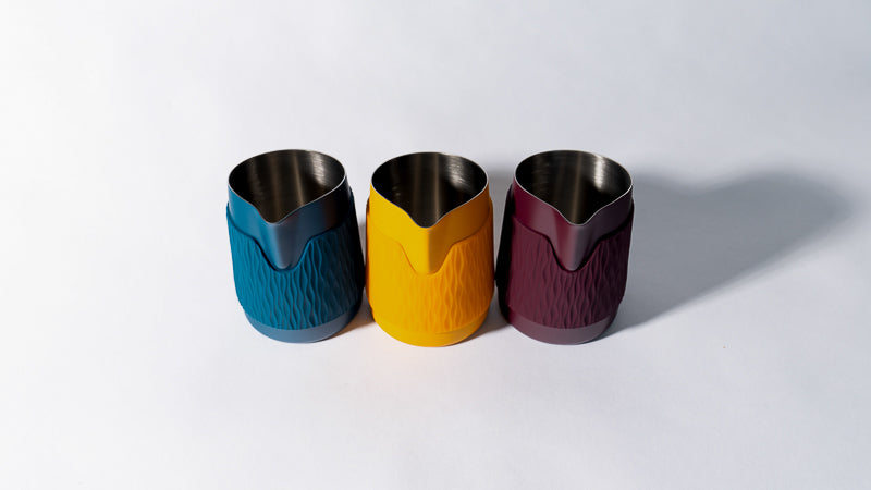 WPM Pitcher handleless latte art pitchers in Marina Blue, Marigold, and Aubegine - designed for precision pouring