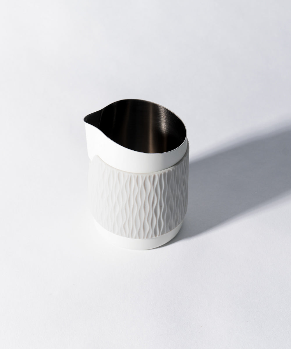 WPM Pitcher in Matte White shown from the side, featuring a sleek handleless design for latte art