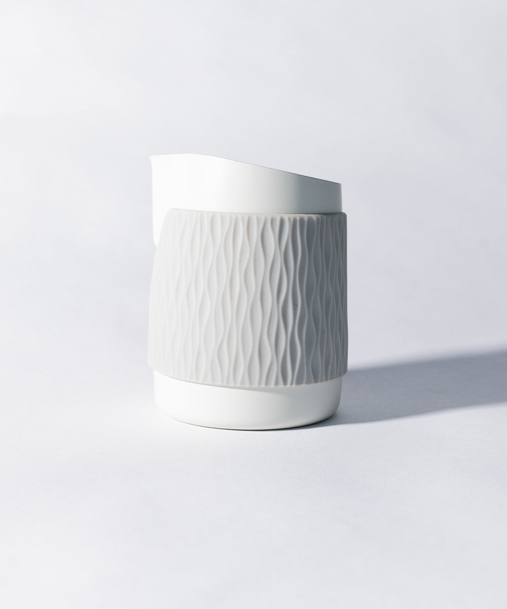 WPM Pitcher in Matte White shown from the side, featuring a sleek handleless design for latte art