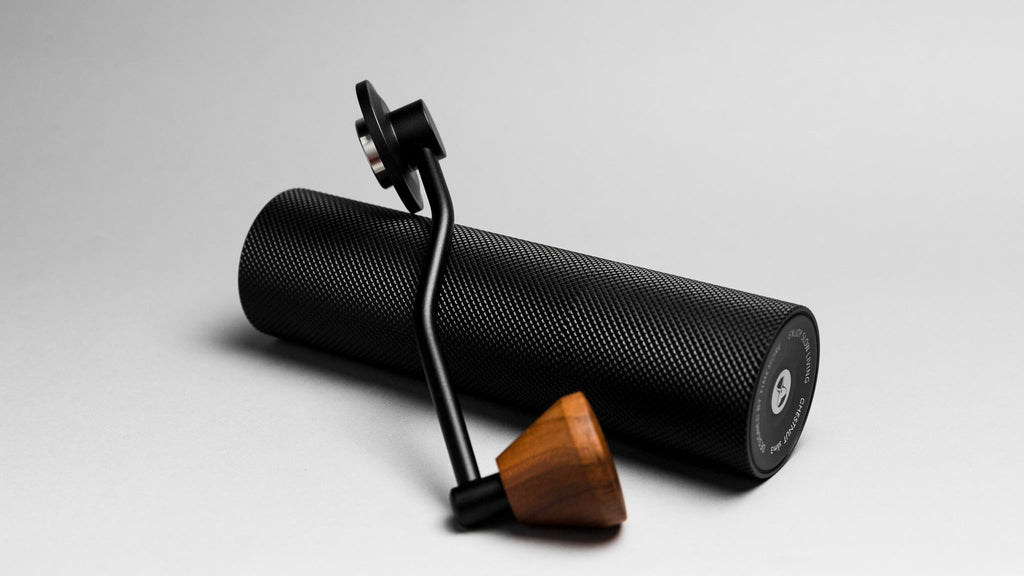 Black textured roller with wooden handle on a light gray background